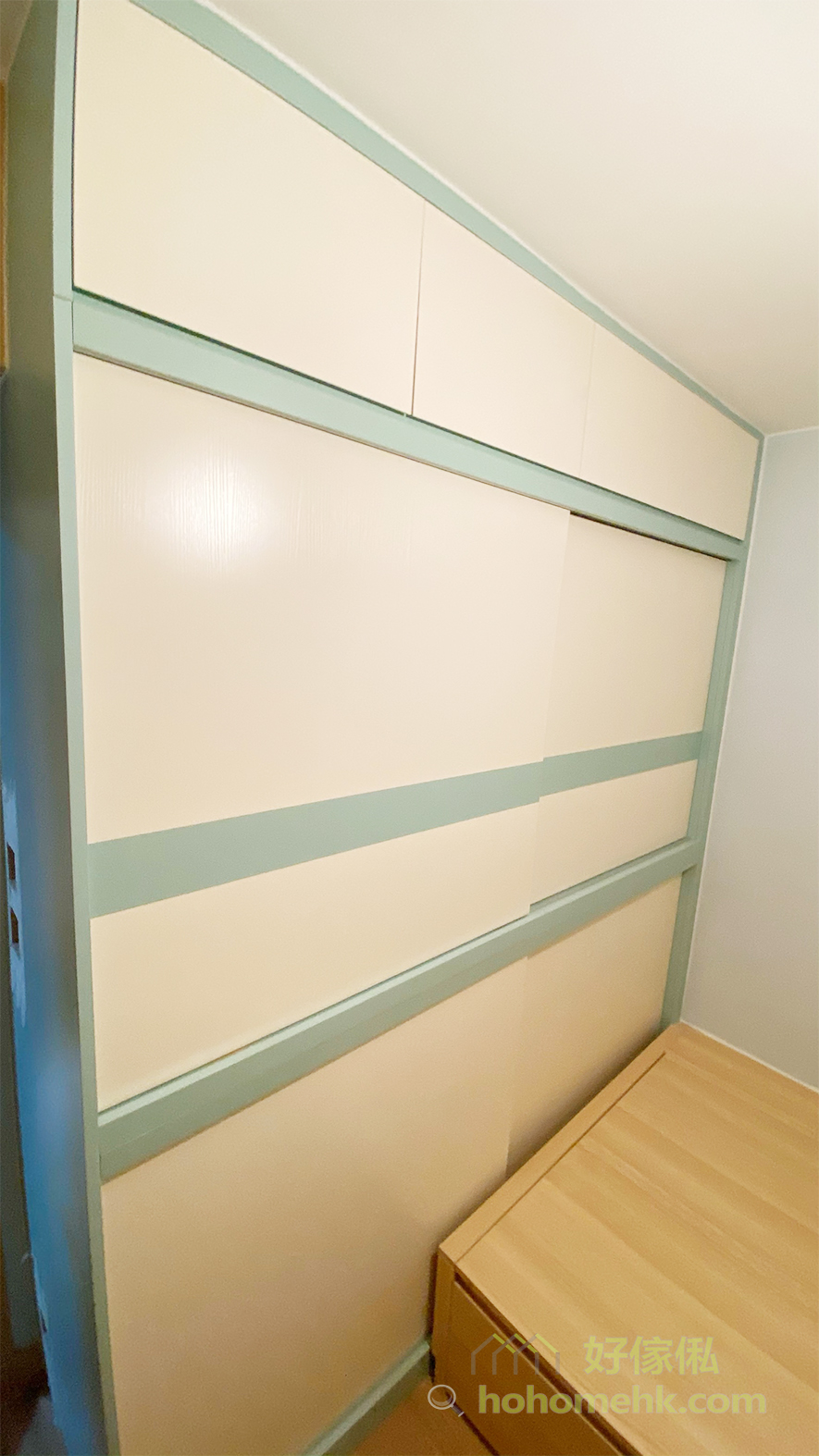 全房以雙主色調客製化系統櫃，粉綠配搭淺木色，再加上大範圍的米白色，展現兩個人的風格